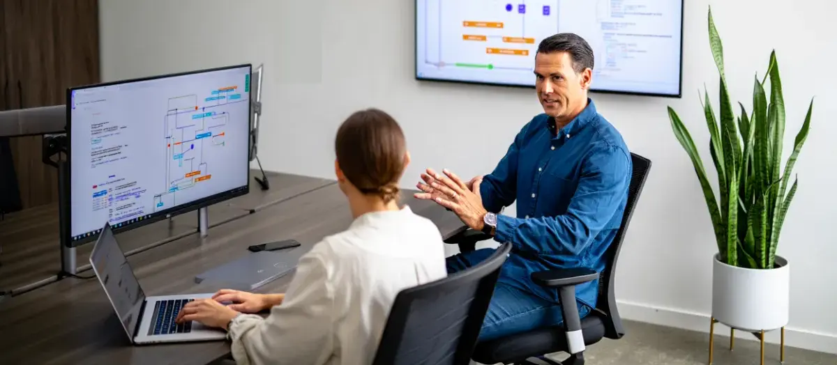 Senior advisor reviewing digital workflows with a colleague